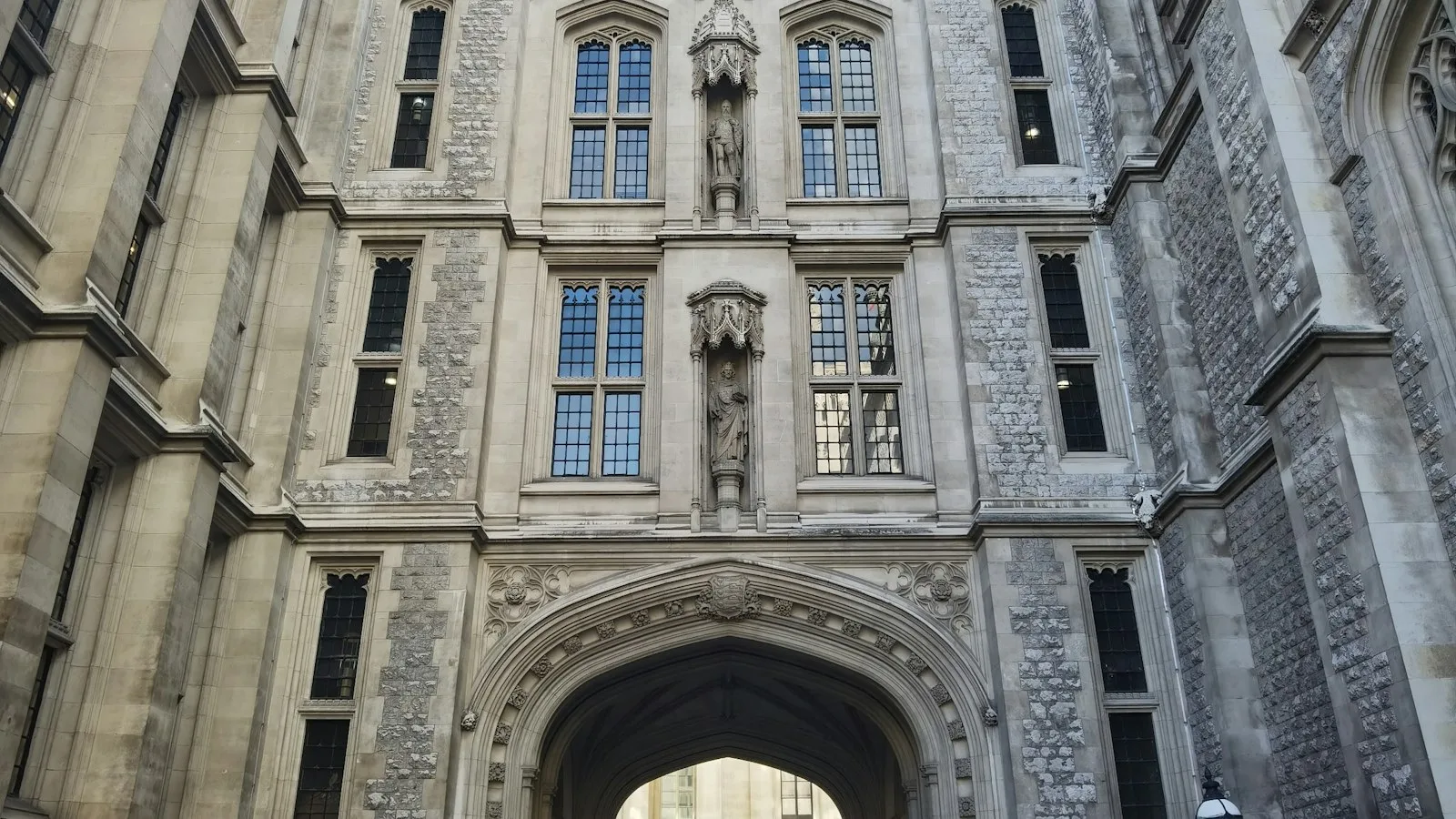Historic stone university building with an arched entrance in the United Kingdom